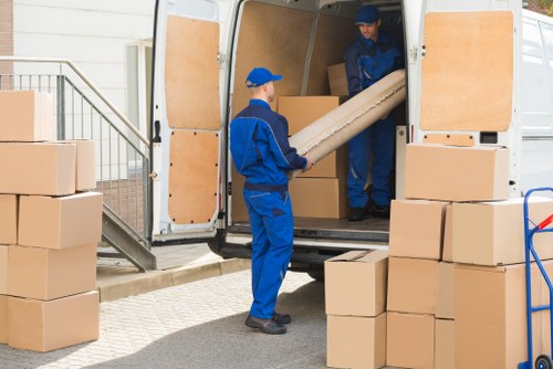 Student moving boxes and furniture in Bow near local flats