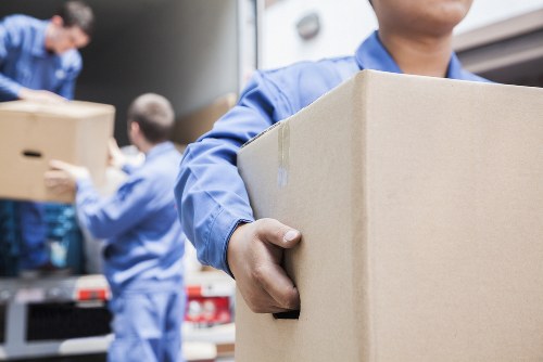 Professional flat removal team handling apartment furniture in Bow