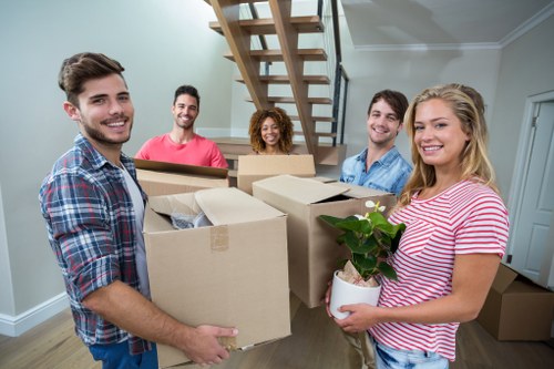 Moving boxes and furniture prepared for a removals service in Bow