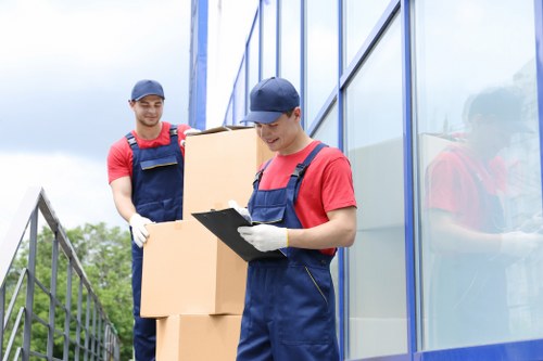 Professional movers handling household items in Bow
