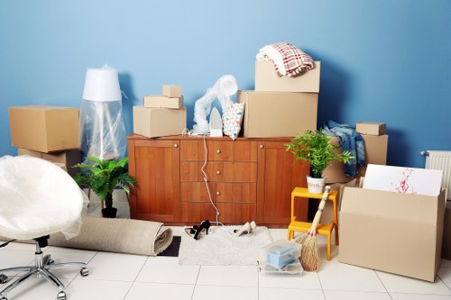 Packed moving boxes and household items ready for house removals in Bow