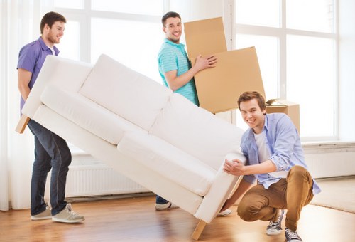 Upright piano being carefully moved through a Bow property