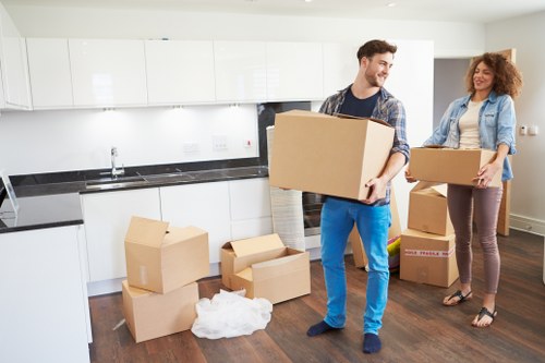 Staff member handling boxes with proper lifting technique