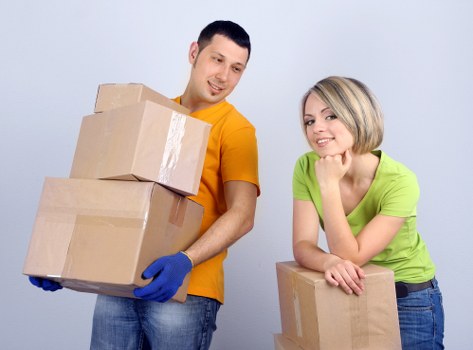 A removals team loading heavy furniture in Bow