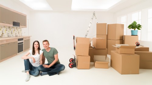 A removals team carrying items while following a safety plan