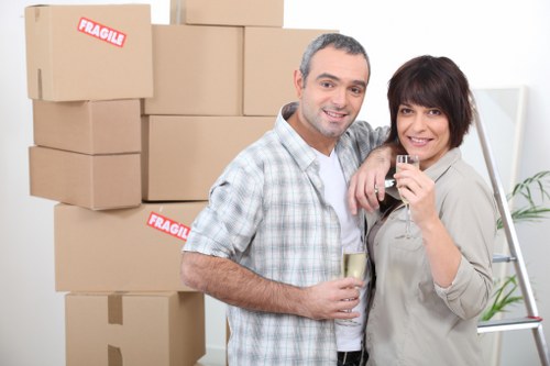 Professional movers loading furniture for a Bow house removal
